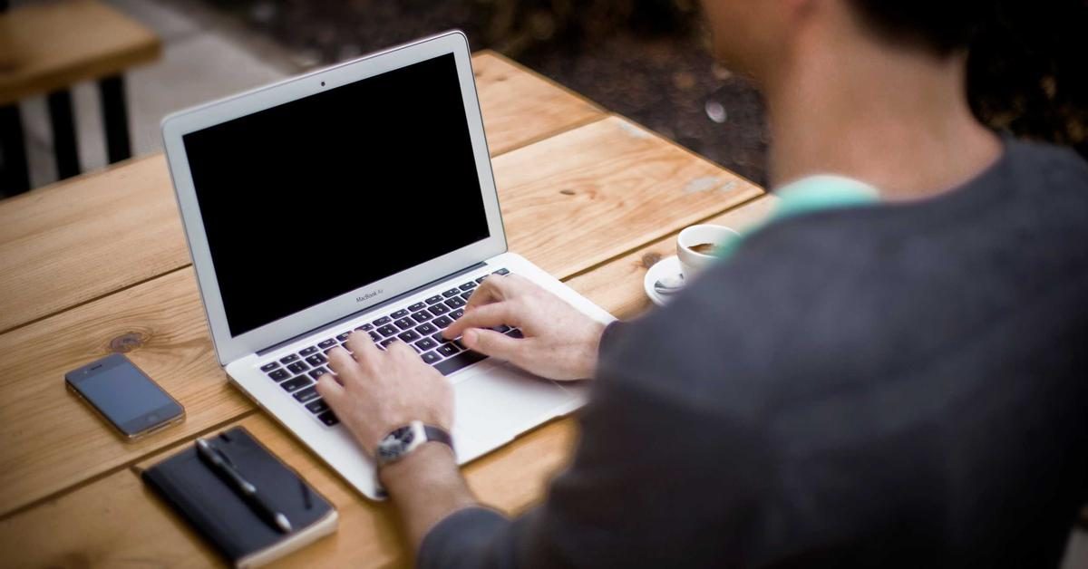 strategies to avoid ai detection - writer editing text on laptop