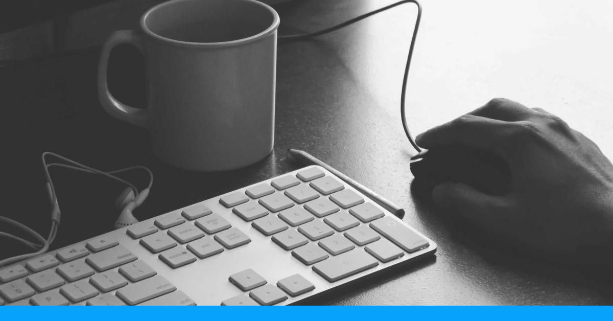 Hands typing on a laptop while editing a text document