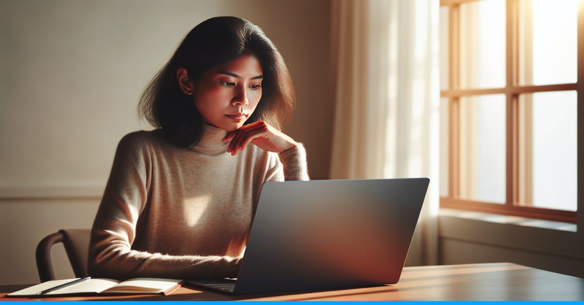 Content writer at desk reviewing before-and-after comparison of AI text versus humanized natural writing on laptop