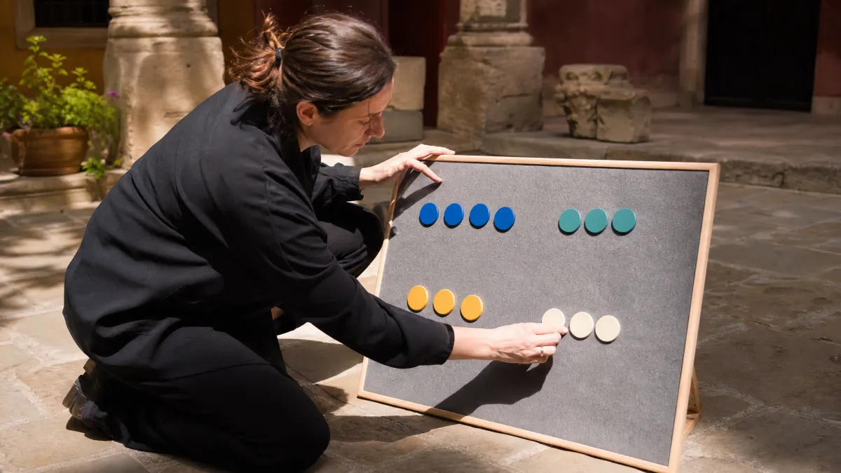 Strategist arranges blank magnets for a color palette from image role map.