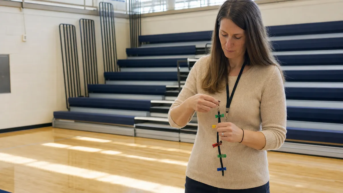 Instructor uses colored clips while asking is Turnitin AI detector accurate for fair review.